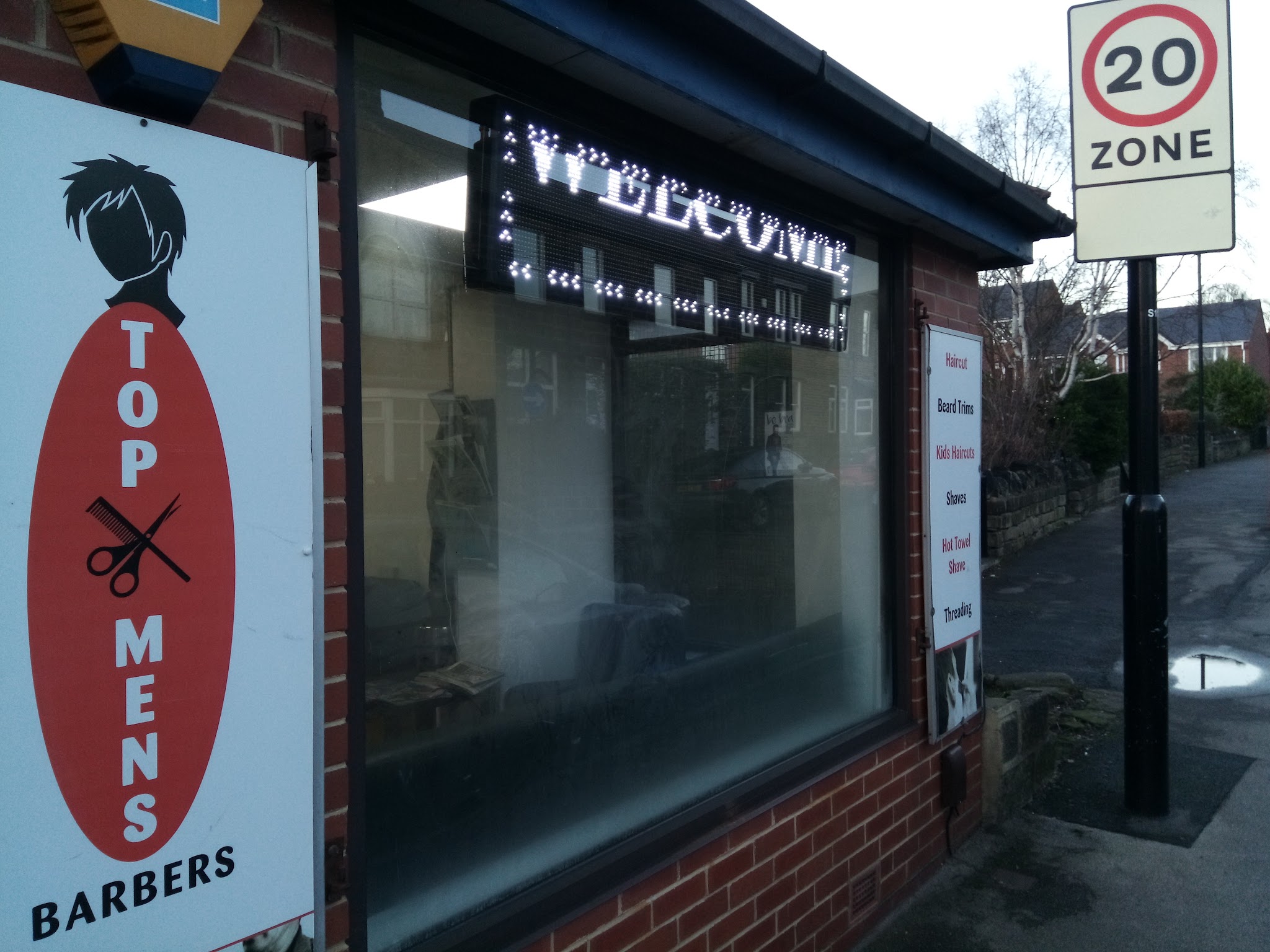 Top Men's Barbers shopfront on Sunnybank Avenue, with its red and black sign