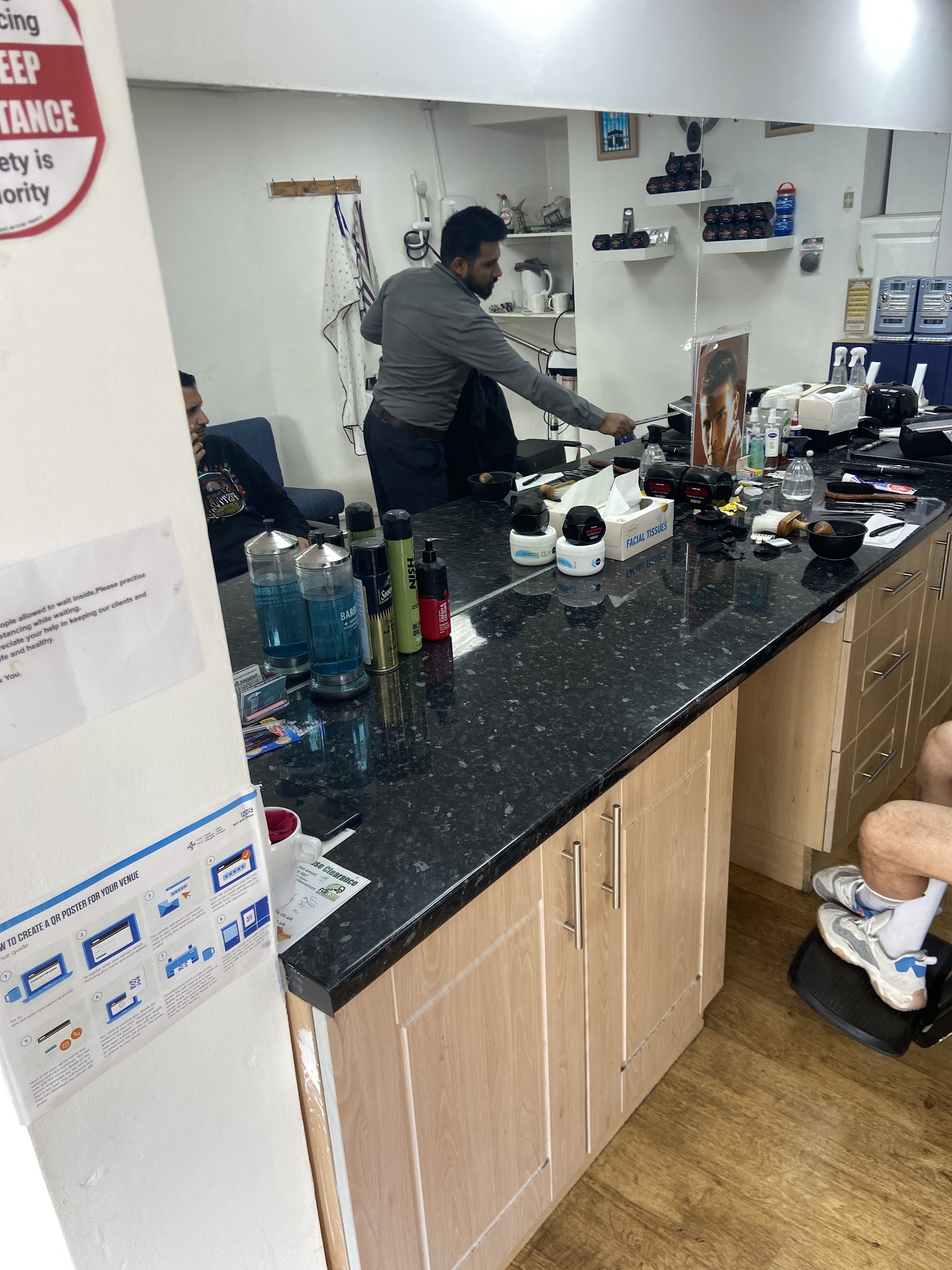 Inside Top Men's Barbers, looking across the counter and mirror